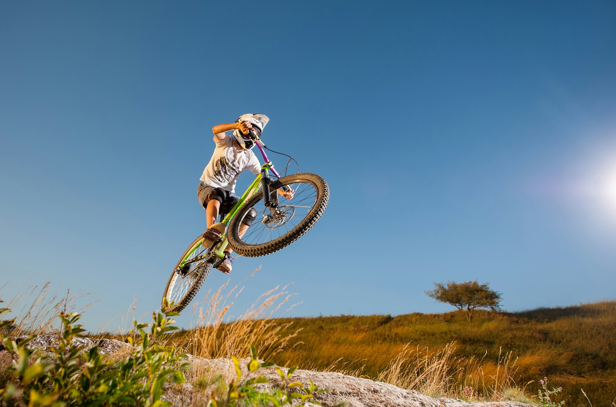 Cyclist riding downhill on mountain bike on the hill